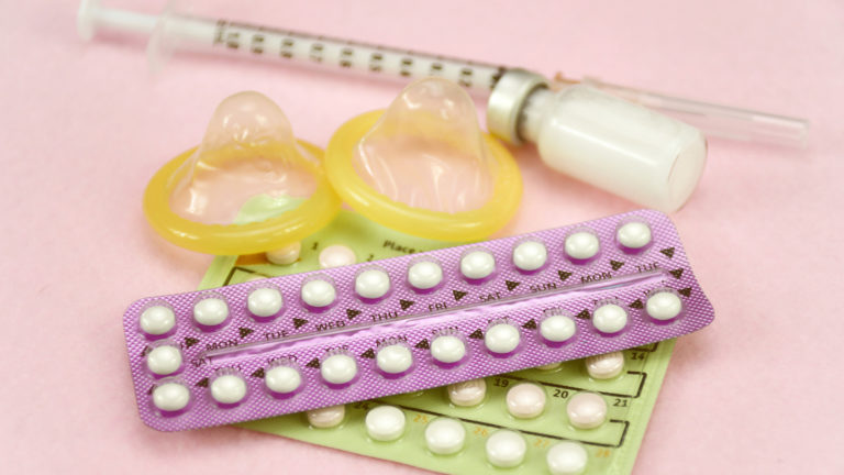 Contraception Education Concept With Oral Contraceptive Pill and Memo Day Strip